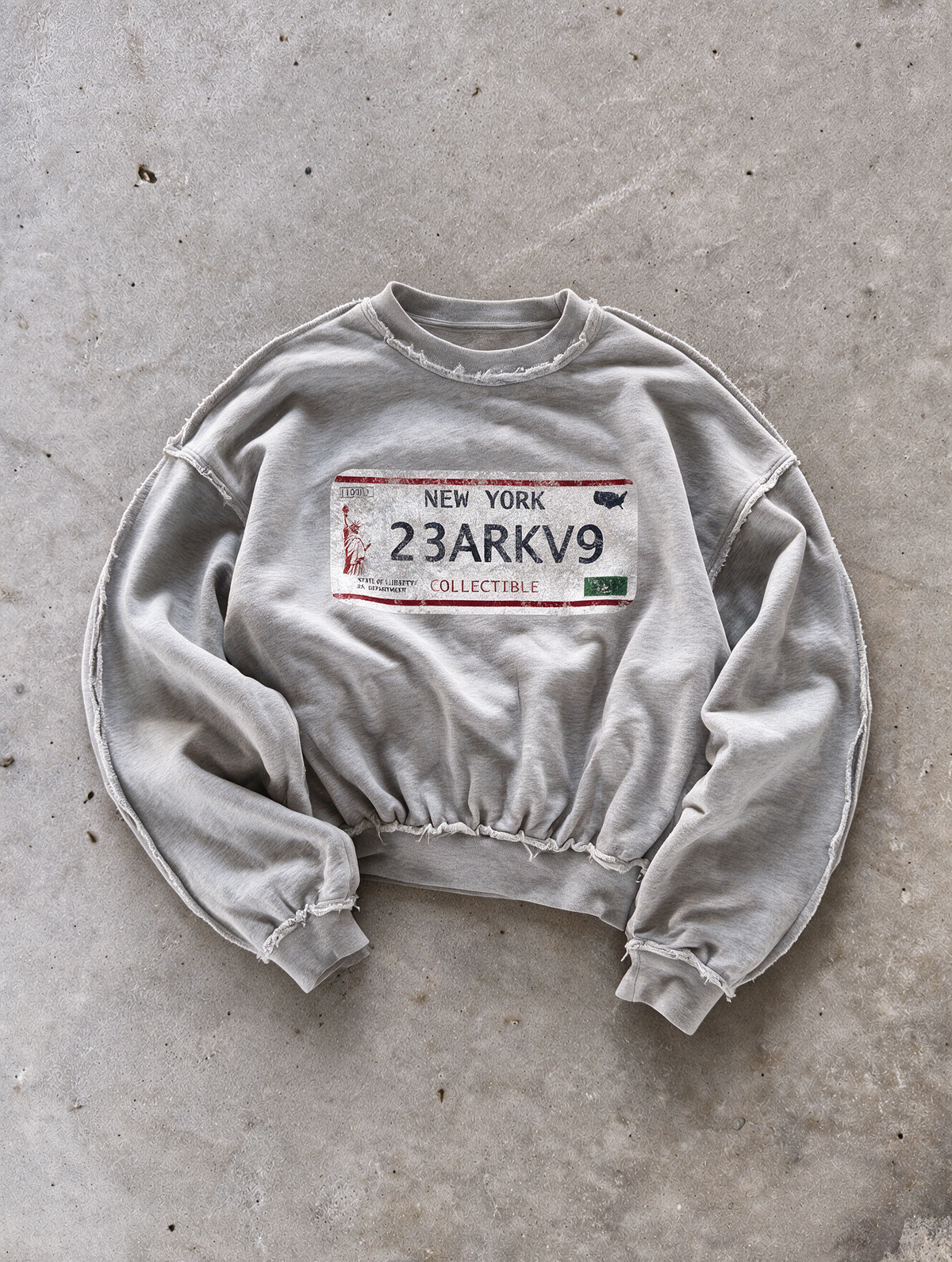 'NY' distressed crewneck sweatshirt in gray, front flat-lay view 1